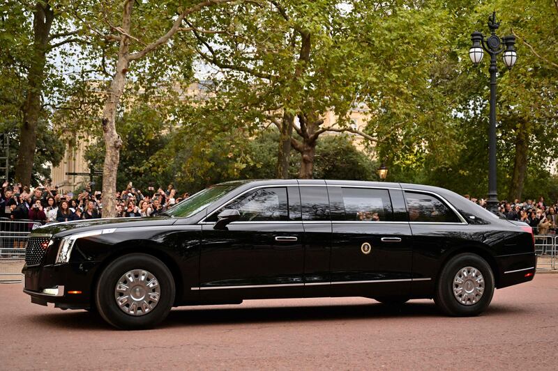 Mr Biden in his presidential car 'The Beast' as it drives to Buckingham Palace on Sunday. AFP