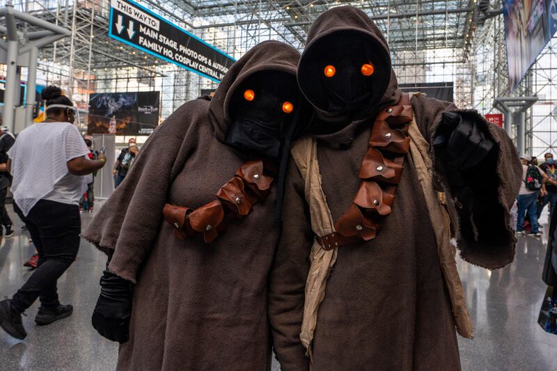 Attendees dressed as Jawas from 'Star Wars' pose during New York Comic Con. Charles Sykes / Invision / AP
