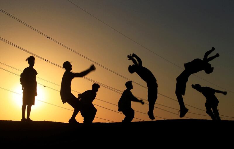 Iraqi youths perform a somersault as they practice parkour in Najaf, Iraq. Reuters