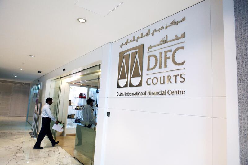 Dubai, Jan 16th, 2012 --  DIFC STOCK -  A businessman walks by DIFC Courts sign. Photo by: Sarah Dea/ The National