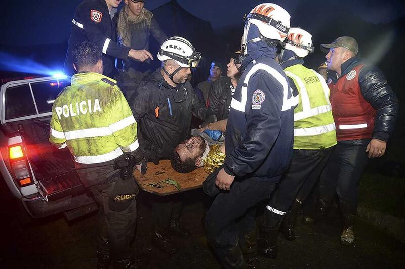 Rescuers carry one of the survivors from the LAMIA airlines charter plane that was carryying members of the Chapecoense Real football team that crashed in the mountains of Cerro Gordo, municipality of La Union. Raul Arboleda / AFP