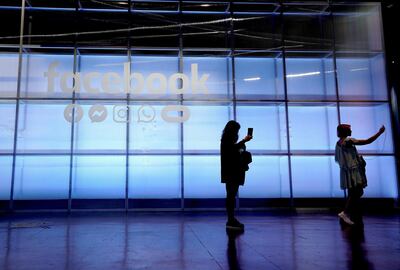 FILE - In this April 30, 2019, file photo attendees take a selfie in front of a Facebook sign at F8, the Facebook's developer conference in San Jose, Calif. Facebook reports financial results on Wednesday, Jan. 29, 2020. (AP Photo/Tony Avelar, File)