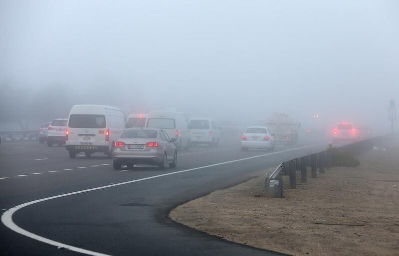 Motorists drive through morning fog on the Dubai - Abu Dhabi highway near Ghantoot in Abu Dhabi on February 4, 2015. Pawan Singh / The National