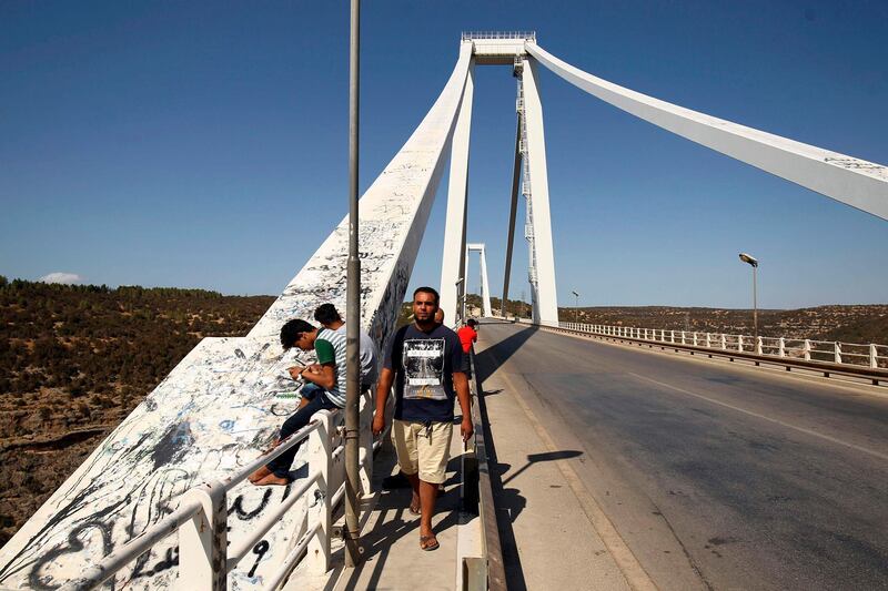 People crossing the Wadi el Kuf bridge, built by Italian architect Riccardo Morandi in northeastern Libya. A 200-metre section of Genoa's Morandi motorway bridge collapsed on August 16. Genoa's structure has two twins in the world: Wadi el Kuf and General Rafael Urdaneta Bridge in Venezuela. AFP