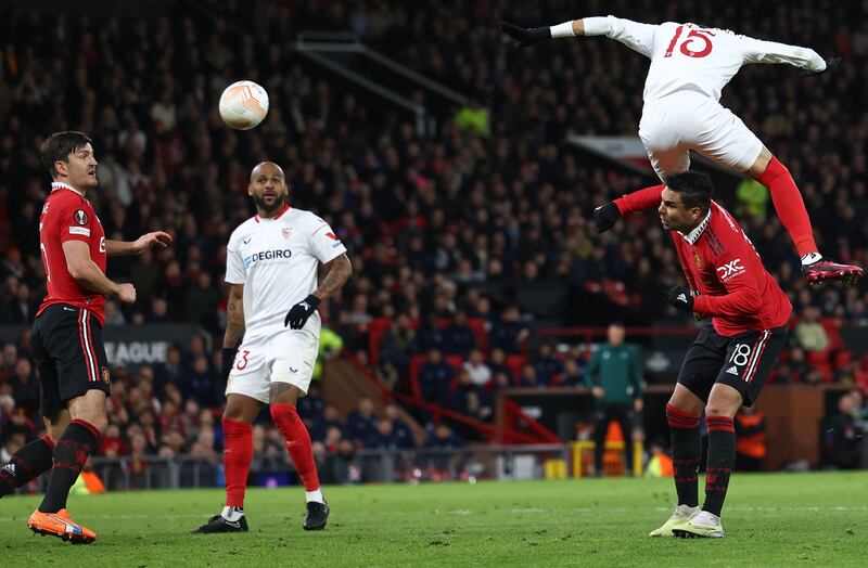 Sevilla's Moroccan forward Youssef En-Nesyri heads the ball to score a second goal, deflected in for an own goal off of Manchester United's English defender Harry Maguire, left. AFP
