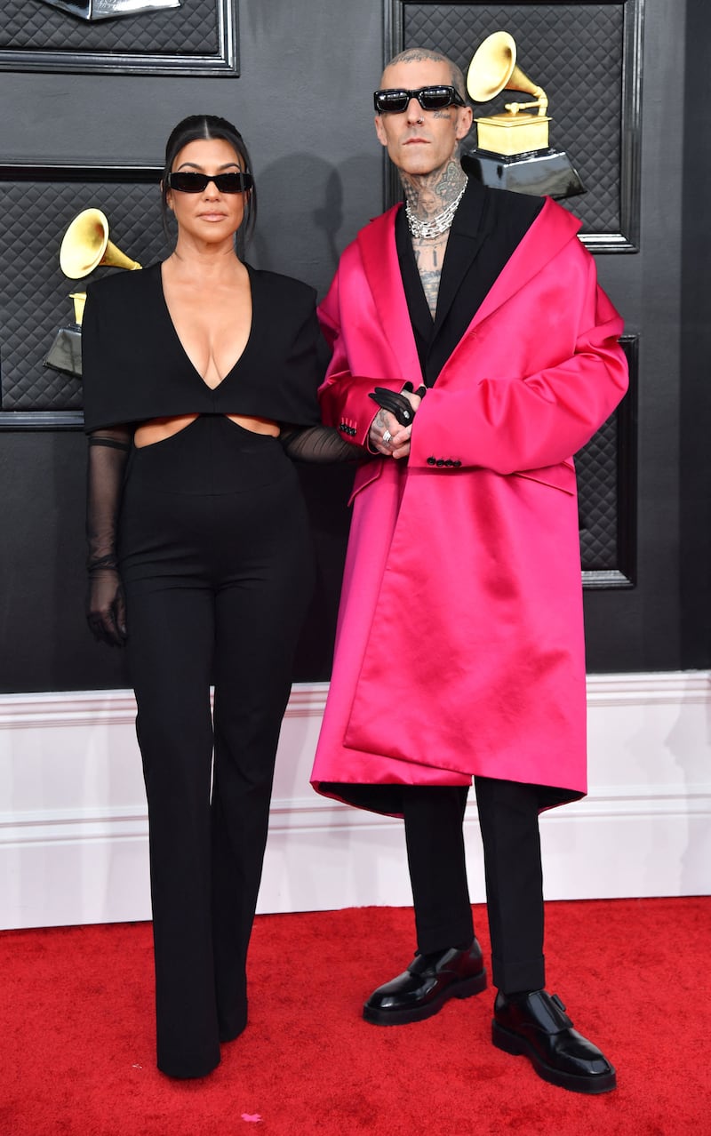 Kourtney Kardashian wore all-black Givenchy, while her fiance Travis Barker wore a pink Givenchy coat over his suit. AFP
