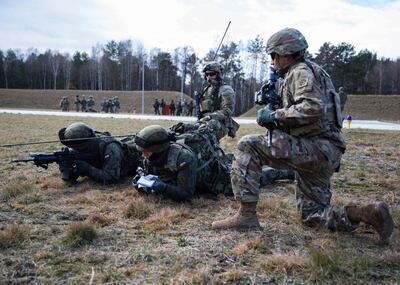 US 82nd Airborne Division paratroopers train alongside their Polish allies in Poland. Experts are calling for a Nato tripwire peacekeepers to be deployed in Ukraine. AFP
