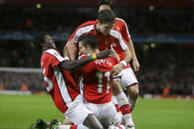 Arsenal's Robin van Persie, center, celebrates after scoring the Gunners' third goal in a 4-0 win against Group G opponents FC Porto.