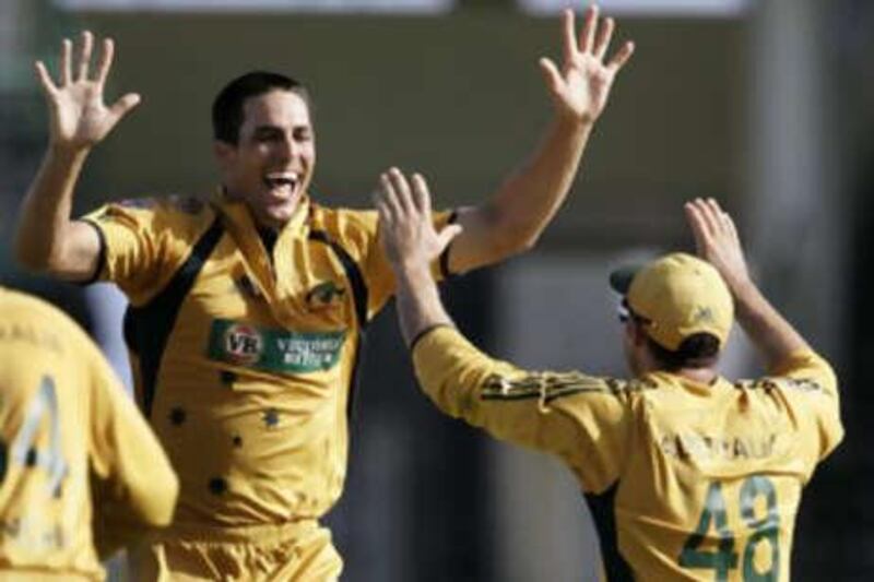 The Australia bowler Mitchell Johnson, left, celebrates with teammate Mike Hussey after taking his last wicket.