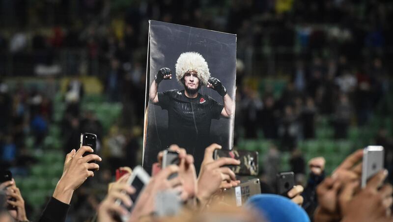 Fans hold a picture of Khabib Nurmagomedov during his speech in Makhachkala. AFP