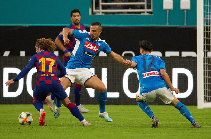 Griezmann tries to get past a Napoli defender. EPA