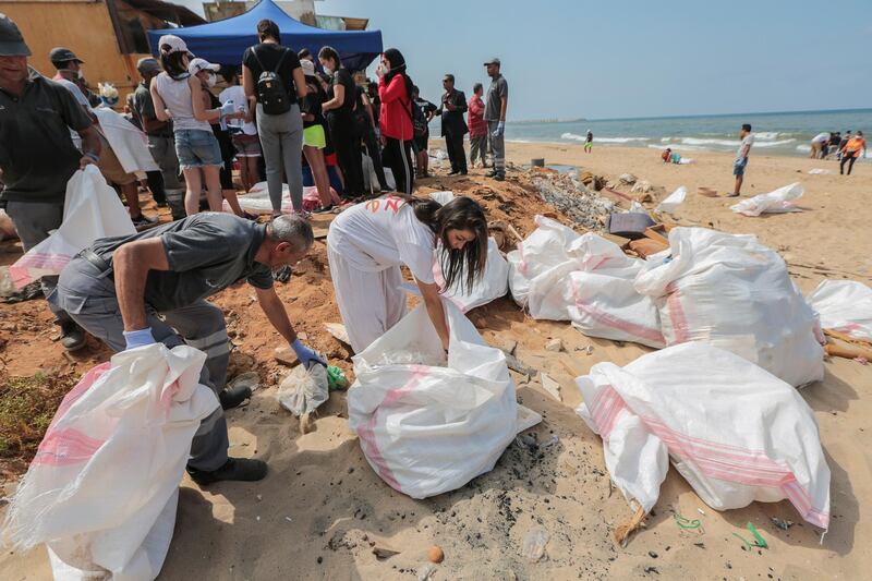 Lebanese activists take part in the clean up of the country's coast, at Al-Ouzai area in Beirut. EPA