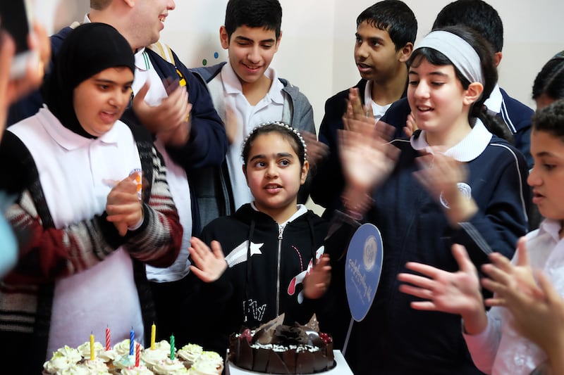 Birthday celebrations with a cake by the Celebrate Life bakery at the Gulf Autism Centre in Abu Dhabi. Delores Johnson / The National
