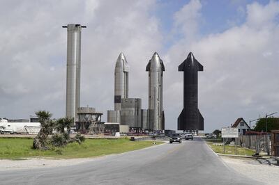 Three Starship rockets alongside a heavy loft booster. The reusable rockets are at the centre of SpaceX's plans for the future. Willy Lowry / The National