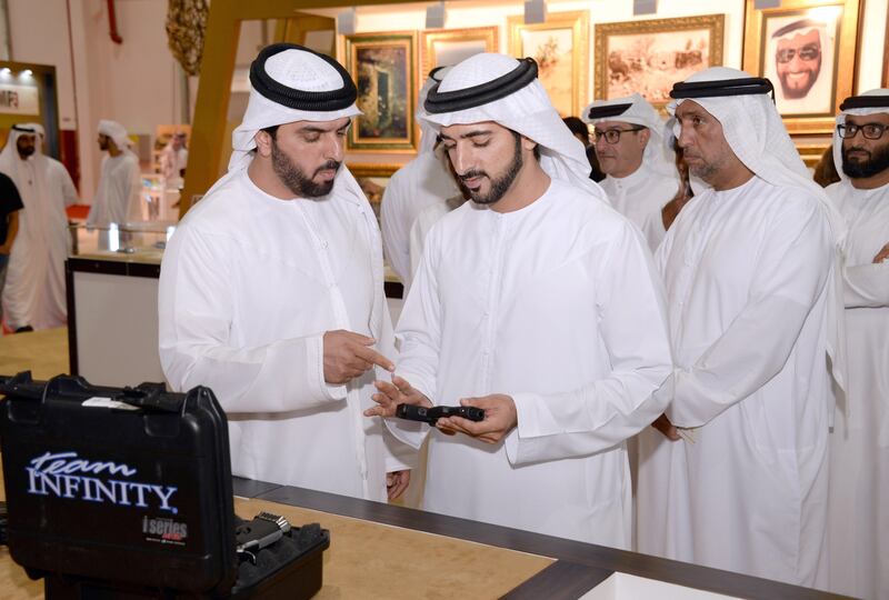 Sheikh Hamdan bin Mohammed, Crown Prince of Dubai, is shown hunting equipment during his tour of Adihex on Friday. Wam
