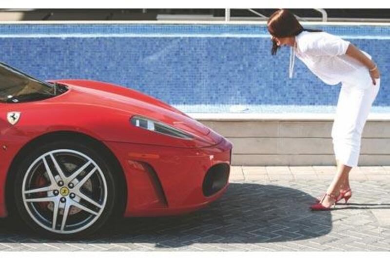 Helena Frith Powell checks out the front of a Ferrari F430 F1 outside The Westin hotel in Dubai.