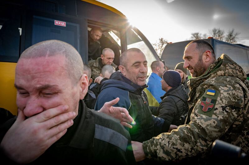 Ukrainian former prisoners of war react following a prisoner exchange with Russia at an undisclosed location in Ukraine. AFP