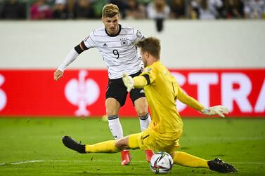 Germany's Timo Werner (L) scores the opening goal versus Liechtenstein's goalkeeper Benjamin Buechel during the FIFA World Cup Qatar 2022 qualifying Group J soccer match between Liechtenstein and Germany, at the kybunpark Stadium, in St.  Gallen, Switzerland, 02 September 2021.   EPA / GIAN EHRENZELLER