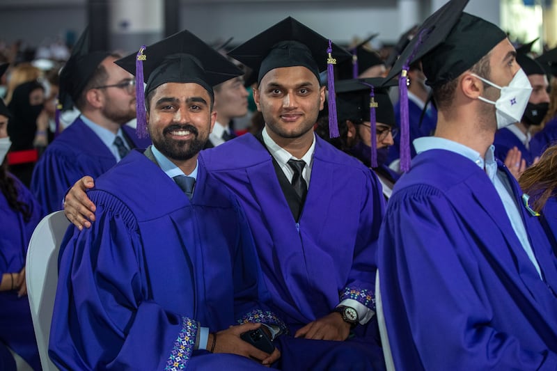 Wajahat Mirza and Uttam Mishra smile on their graduation day.