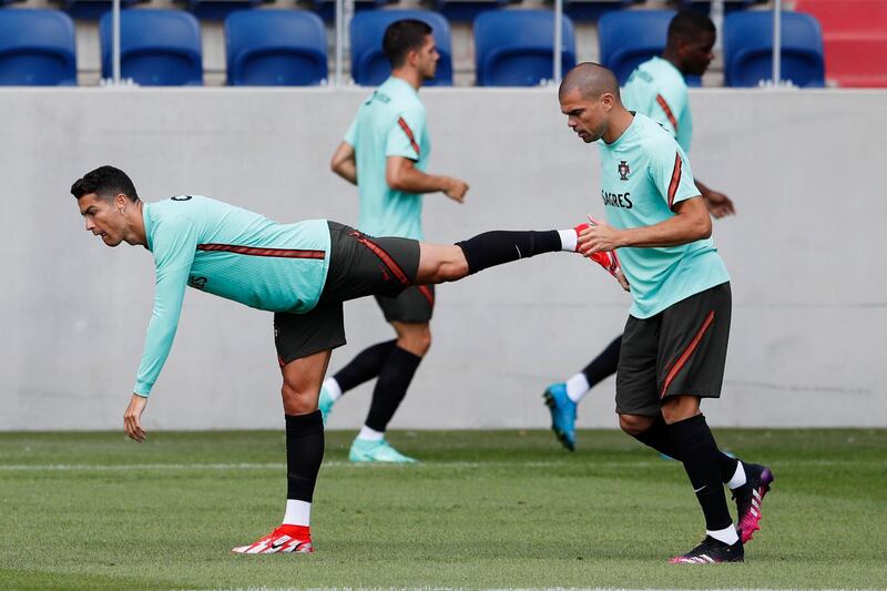 Cristiano Ronaldo and Pepe stretch during a training session at Illovszky Rudolf Stadium. Reuters