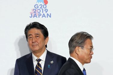 South Korean President Moon Jae-In, right, and Japanese Prime Minister Shinzo Abe, left, at the G20 summit in June in Osaka, Japan. Kim Kyung-Hoon / Getty