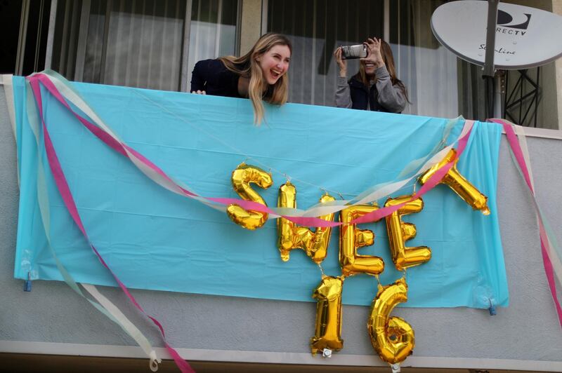 Lily Haines, left, celebrates her sixteenth birthday on her apartment balcony in Los Angeles, California. Reuters