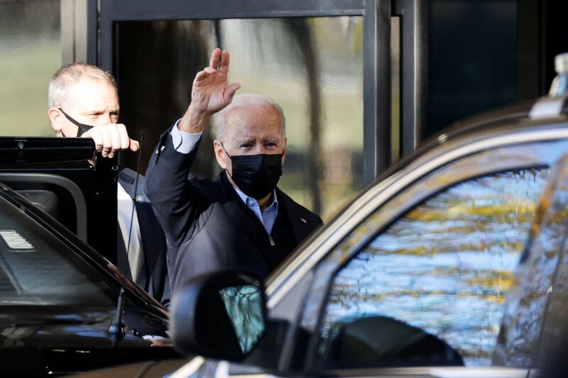 US President Joe Biden waves to reporters as he arrives for his annual physical at Walter Reed National Military Medical Centre in Bethesda, Maryland. Reuters