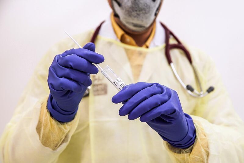 Abu Dhabi, United Arab Emirates, March 18, 2020.  
   Dr. Faisal secures a swab in a vial after doing a coronavirus test at the Burjeel Hospital, Abu Dhabi.
Victor Besa / The National
Reporter:  Ramola Talwar
Section:  NA
