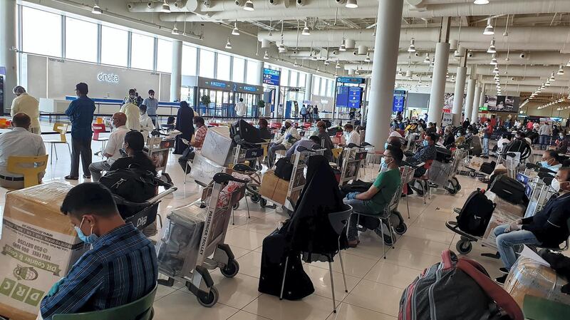 Passengers wait for flights at Dubai International Airport on Thursday afternoon. Indian Consulate
