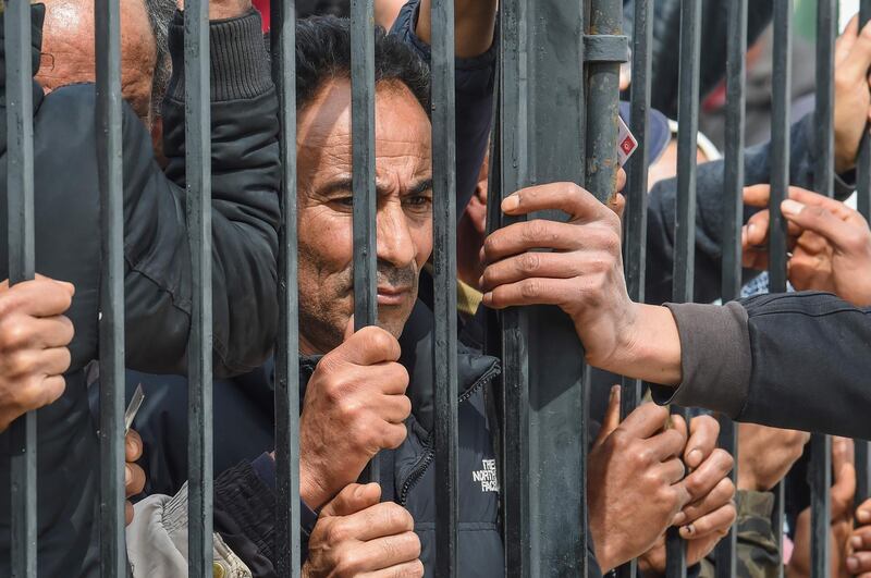 Impoverished Tunisian citizens gather in front of the headquarters of Mnihla delegation in Ariana Governorate. AFP