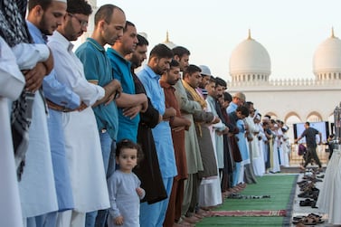 Worshippers perform morning prayers on the first day of Eid Al Fitr at the Sheikh Zayed Grand Mosque in Abu Dhabi. Leslie Pableo for The National