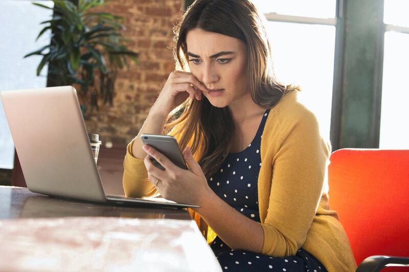 Stressed Caucasian businesswoman using cell phone