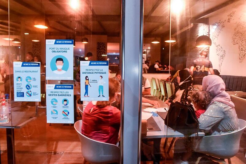 Notices are plastered at the entrance of a restaurant in Algiers, reminding customers to respect safety measures against the novel coronavirus after lockdown restrictions were eased by the authorities. AFP