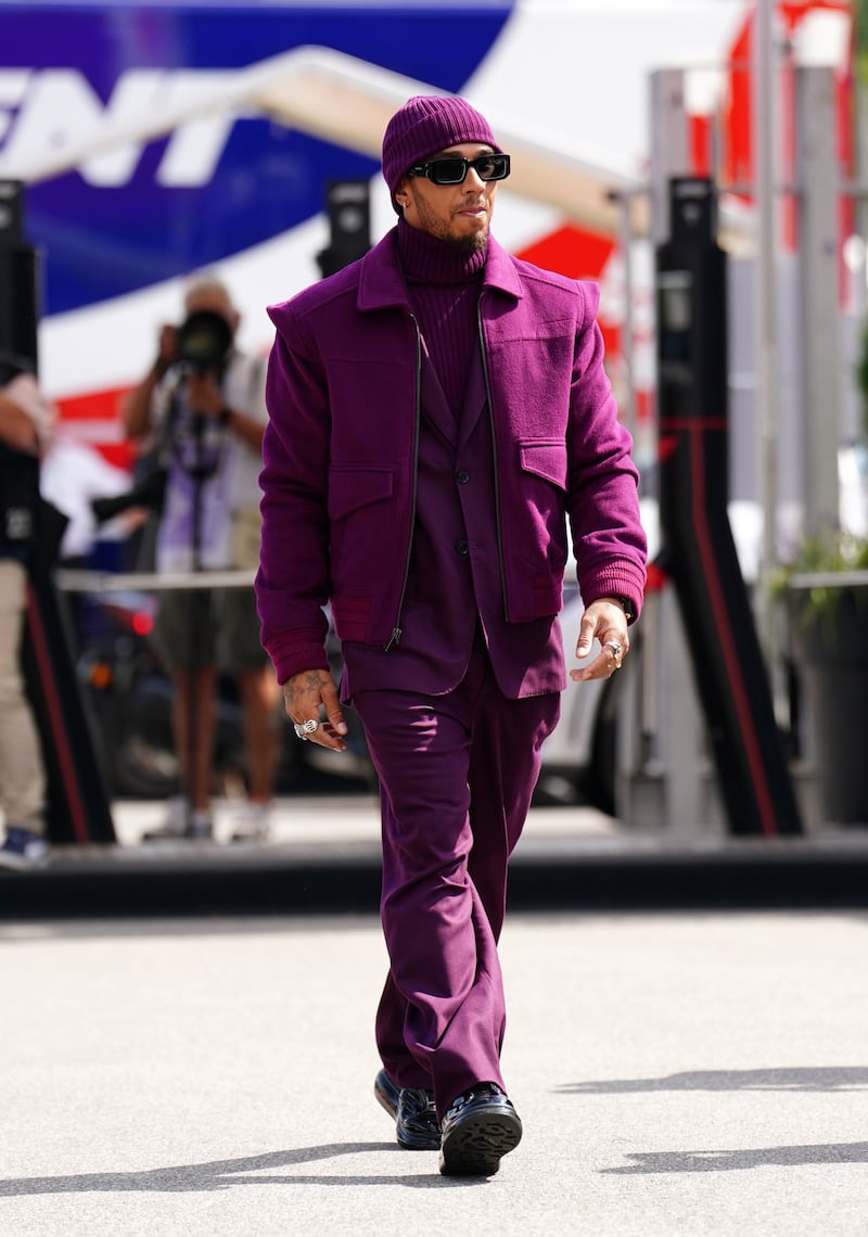 Lewis Hamilton, in an all-purple look by Teddy Vonranson, arrives at the Italian Grand Prix in Monza on September 8, 2022. AFP