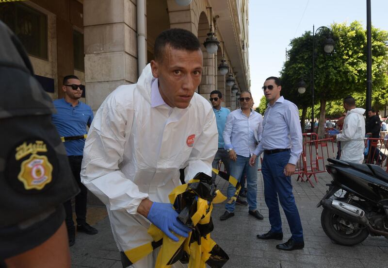 Tunisian forensic police work at the site of attack in the Tunisian capital's main avenue Habib Bourguiba.  AFP