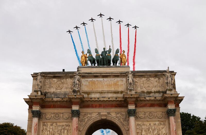 Alpha jets from the French Air Force Patrouille de France fly past the Arc de Triomphe during the Bastille Day celebrations in Paris, France. Reuters
