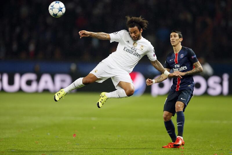 Real Madrid defender Marcelo jumps for the ball with Angel Di Maria of Paris Saint-Germain nearby during their Champions League contest on Wednesday. Ian Langsdon / EPA