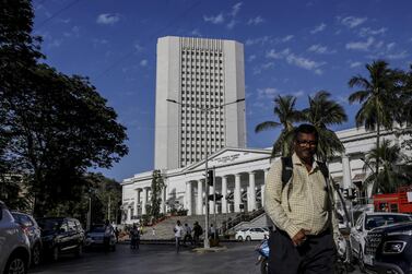 A pedestrian walks past the Reserve Bank of India in Mumbai. The RBI said it is ready to act to maintain market confidence and preserve financial stability. Bloomberg