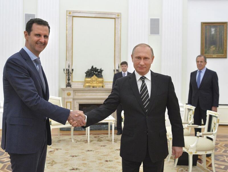 Russian president Vladimir Putin shakes hands with Syrian president Bashar Al Assad during a meeting at the Kremlin in Moscow. Alexei Druzhinin / Reuters