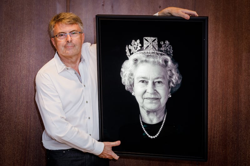 Rob Munday unveils a never seen before portrait of Queen Elizabeth at 45 Park Lane in London in May this year. Getty Images