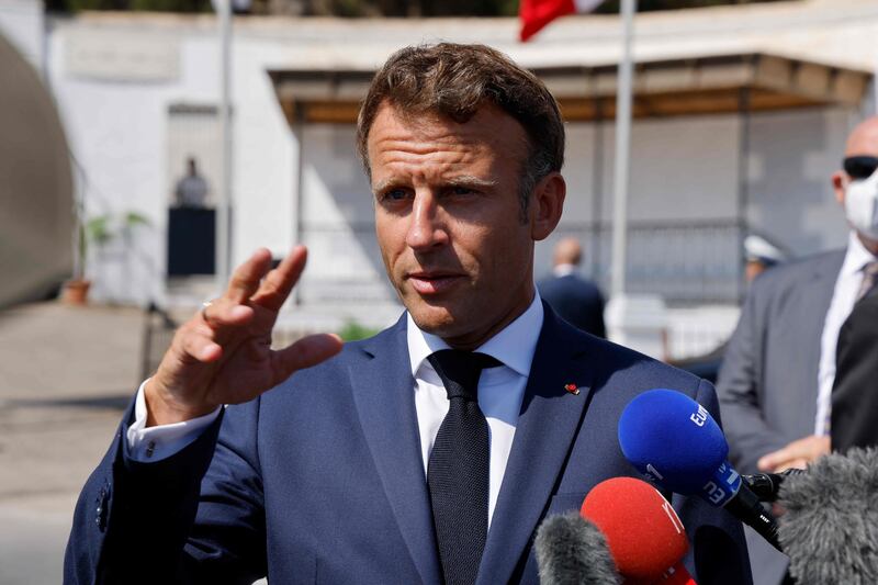 French President Emmanuel Macron speaks to the press after visiting the Christian cemetery of Saint-Eugene in Algiers on August 26, 2022.  - The French president started a three-day visit to Algeria on August 25, to help mend ties with the former French colony, which this year marks its 60th anniversary of independence.  (Photo by Ludovic MARIN  /  AFP)