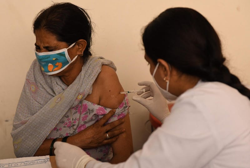 A medical worker inoculates a woman with a dose of the Covishield vaccine at a hospital in Amritsar. AFP