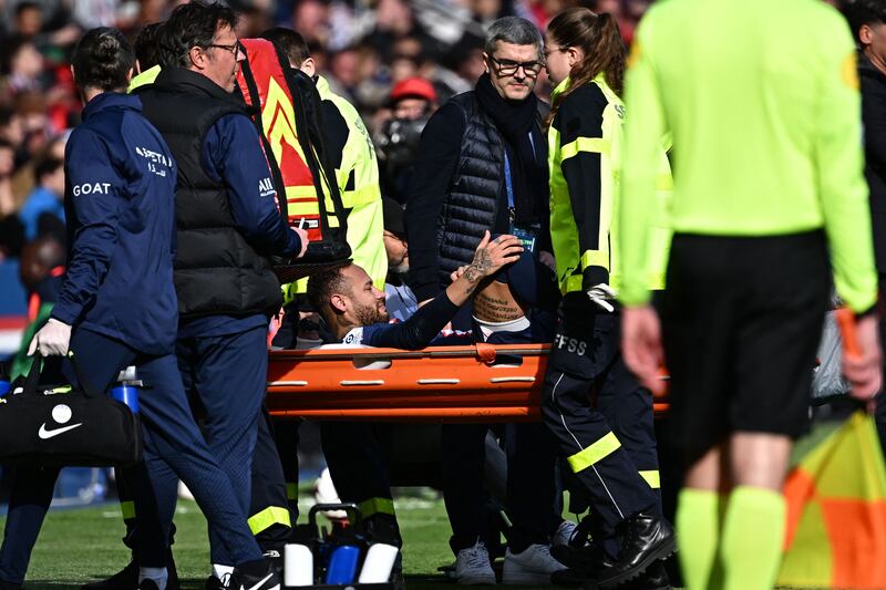 Neymar is carried off the pitch after his injury against Lille.  AFP