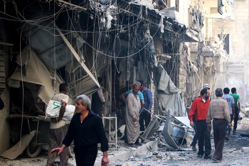 Civil defence members and men inspect a site damaged after an air strike on the besieged rebel-held Al Qaterji neighbourhood of Aleppo on October 11, 2016. Abdalrhman Ismail/Reuters