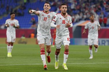 UAE's forward Caio Canedo (C-L) celebrates with teammates after scoring the opening goal during the FIFA Arab Cup 2021 group B football match between UAE and Syria at the Ras Abu Aboud Stadium in Doha on November 30, 2021.  (Photo by JACK GUEZ  /  AFP)