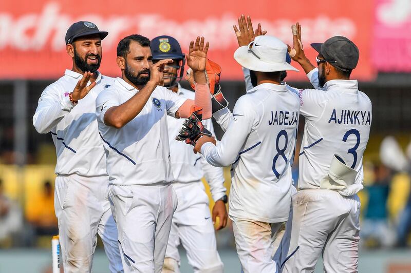 India's Mohammed Shami, second left, celebrates with teammates after the dismissal of Bangladesh batsman Taijul Islam. AFP