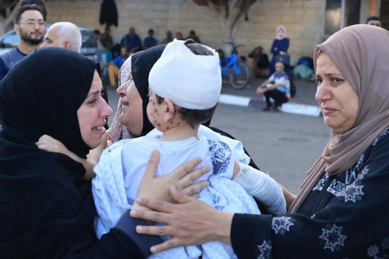 Women cry as one of them holds an injured toddler outside Shuhada Al Aqsa hospital after an Israeli bombardment of Deir Balah, in the central Gaza Strip. AFP