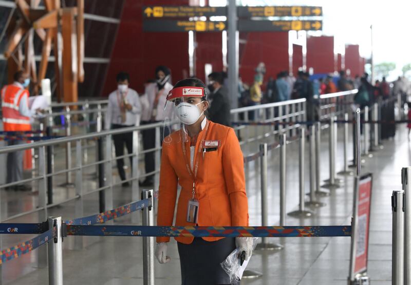 epa08442833 A flight attendant wearing protective gear is seen at Indira Gandhi International Airport in New Delhi, India, 25 May 2020. According to reports, the Indian government has allowed domestic flights to resume on 25 May after they were stopped due to the coronavirus outbreak.  EPA-EFE/RAJAT GUPTA *** Local Caption *** 56107602