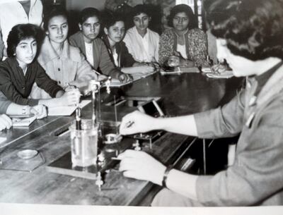 Lamees Ibrahim, fourth from left in the science lab as a schoolgirl in Baghdad, would go on to complete a PhD in pathology at King's College London. Courtesy Lamees Ibrahim 