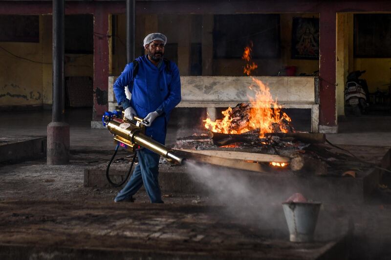 A volunteer sprays disinfectant at the Shivpuri Hindu cremation ground during a government-imposed nationwide lockdown, in Amritsar.  AFP